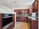 Well-lit kitchen featuring tile floors, granite countertops, and dark wood cabinets at 43 E Agate Ave # 403, Las Vegas, NV 89123