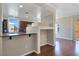 Bright kitchen featuring granite countertops, dark wood cabinetry, and open layout overlooking the living area at 43 E Agate Ave # 403, Las Vegas, NV 89123