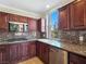 Kitchen featuring stainless steel appliances, granite countertops, and dark wood cabinetry at 43 E Agate Ave # 403, Las Vegas, NV 89123