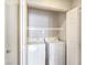 An enclosed laundry area featuring a white washer and dryer, plus shelving at 43 E Agate Ave # 403, Las Vegas, NV 89123