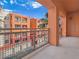 Balcony area with metal railing overlooking colorful buildings and blue sky at 43 E Agate Ave # 403, Las Vegas, NV 89123