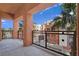 Balcony area with metal railing overlooking palm trees and colorful buildings at 43 E Agate Ave # 403, Las Vegas, NV 89123