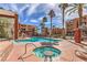 Inviting outdoor pool and spa area surrounded by lush landscaping and comfortable lounge seating at 43 E Agate Ave # 403, Las Vegas, NV 89123