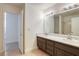 Bright bathroom with double vanity and large mirror at 4420 Resthaven Cir, North Las Vegas, NV 89032