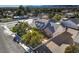 An inviting home with a brick driveway, mature trees, white picket fence, and a backdrop of scenic mountain views at 5110 N Valadez St, Las Vegas, NV 89149
