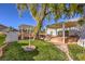 Landscaped backyard with pergola, pond, and brick patio at 5110 N Valadez St, Las Vegas, NV 89149
