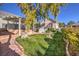 Landscaped backyard with pergola, pond and brick pathway at 5110 N Valadez St, Las Vegas, NV 89149