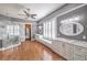 An elegant bathroom with a glass shower, dual sinks, and a window bench, all highlighted by hardwood floors at 5110 N Valadez St, Las Vegas, NV 89149