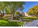 A charming home with a lush front lawn, picturesque landscaping, a white picket fence, and inviting curb appeal at 5110 N Valadez St, Las Vegas, NV 89149