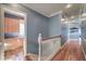 Upstairs hallway with hardwood floors and access to laundry at 5110 N Valadez St, Las Vegas, NV 89149