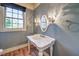 Elegant powder room with pedestal sink and hardwood floors at 5110 N Valadez St, Las Vegas, NV 89149