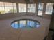 Relaxing indoor hot tub with tiled surround and large windows providing natural light and views at 5260 Mission Monterey Ln # 101, Las Vegas, NV 89107