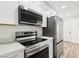 Modern kitchen featuring stainless steel appliances and white cabinets at 5260 Mission Monterey Ln # 101, Las Vegas, NV 89107