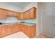 Kitchen features wood cabinets and a corner sink at 5884 Del Rey Ave, Las Vegas, NV 89146