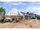 Backyard featuring a greenhouse, white home and some scattered debris at 6324 Fairwood Ave, Las Vegas, NV 89107