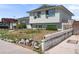 Side view of a two-story home, showing simple landscaping and a concrete barrier with decorative cutouts at 6324 Fairwood Ave, Las Vegas, NV 89107