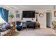Bright living area with a large TV, piano, and unique decor offering a lived-in feel at 6324 Fairwood Ave, Las Vegas, NV 89107