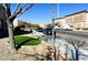 Residential street view with artificial turf and parked cars at 6329 Kitamaya St, North Las Vegas, NV 89031