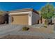 One-story house with tan garage door and landscaped yard at 708 Bridgeford Ct, Henderson, NV 89011