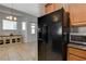 Modern kitchen with black appliances and light wood cabinets at 708 Bridgeford Ct, Henderson, NV 89011