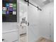 View of a barn door and white bathroom vanity at 779 Omaggio Pl, Henderson, NV 89011