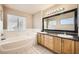 Double vanity bathroom with large mirror and tiled flooring at 7808 License St, Las Vegas, NV 89131
