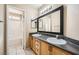 Bathroom boasts double sinks, a large mirror, and a bathtub at 7808 License St, Las Vegas, NV 89131
