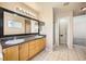 Main bathroom with double sinks, shower, and tiled floor at 7808 License St, Las Vegas, NV 89131