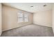 Spacious bedroom with carpet flooring and dual pane windows at 7808 License St, Las Vegas, NV 89131