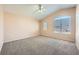 Large bedroom with vaulted ceilings, ceiling fan and carpet flooring at 7808 License St, Las Vegas, NV 89131