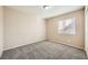 Well-lit bedroom with neutral walls and carpet flooring at 7808 License St, Las Vegas, NV 89131