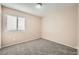 Bright bedroom with carpet flooring and a window with blinds at 7808 License St, Las Vegas, NV 89131