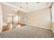 Dining room with hardwood and carpet flooring, and a chandelier at 7808 License St, Las Vegas, NV 89131