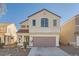 Two-story house with beige exterior, taupe garage door, and landscaping at 7808 License St, Las Vegas, NV 89131
