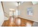 Living room with hardwood floors, high ceilings, and a staircase at 7808 License St, Las Vegas, NV 89131