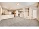 Spacious living room with neutral carpeting and built-in shelving at 7808 License St, Las Vegas, NV 89131