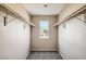 Bright walk-in closet with window and double hanging rods at 7808 License St, Las Vegas, NV 89131
