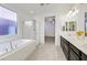 Elegant bathroom with double sinks, soaking tub, and shower at 8115 Lennox View Ln, Las Vegas, NV 89113