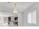 Bright dining room with chandelier and kitchen view at 8115 Lennox View Ln, Las Vegas, NV 89113