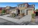 Two-story house with stone accents and a two-car garage at 824 Bluebird Hill Ave, North Las Vegas, NV 89084