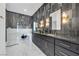 Spa-like bathroom with double vanity, walk-in shower, and dark tile at 8924 Rainbow Ridge Dr, Las Vegas, NV 89117