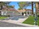 Beautiful home with a tile roof, two-car garage, and landscaped yard at 8924 Rainbow Ridge Dr, Las Vegas, NV 89117