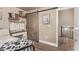 Bedroom with barn door, built-in shelves, and access to upper floor at 9132 Forest Willow Ave # 102, Las Vegas, NV 89149