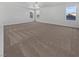 Large bedroom with carpet, ceiling fan, and multiple windows at 10375 Beallsville St, Las Vegas, NV 89141