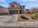 Two-story house with attached garage and desert landscaping at 10375 Beallsville St, Las Vegas, NV 89141