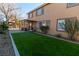 Artificial turf, patio, and view of two-story home at 10744 Balsam Creek Ave, Las Vegas, NV 89144