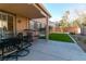 Covered patio with artificial turf, seating area, and a sandbox at 10744 Balsam Creek Ave, Las Vegas, NV 89144