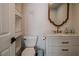 Stylish powder room with a pedestal sink and decorative mirror at 10744 Balsam Creek Ave, Las Vegas, NV 89144