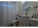 Clean bathroom with a white vanity, shower curtain, and a big mirror at 10744 Balsam Creek Ave, Las Vegas, NV 89144