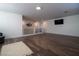 Spacious bonus room with hardwood floors and a large TV at 10744 Balsam Creek Ave, Las Vegas, NV 89144